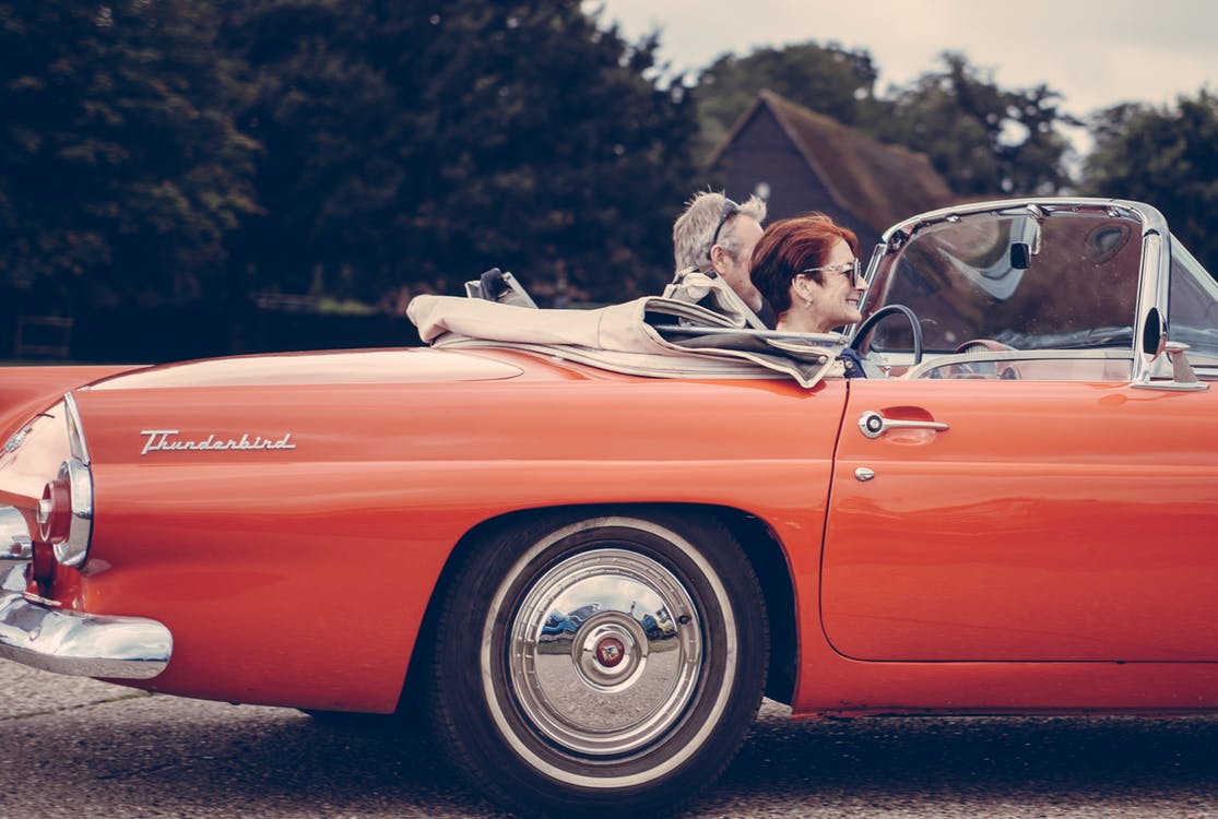 Couple driving sports car