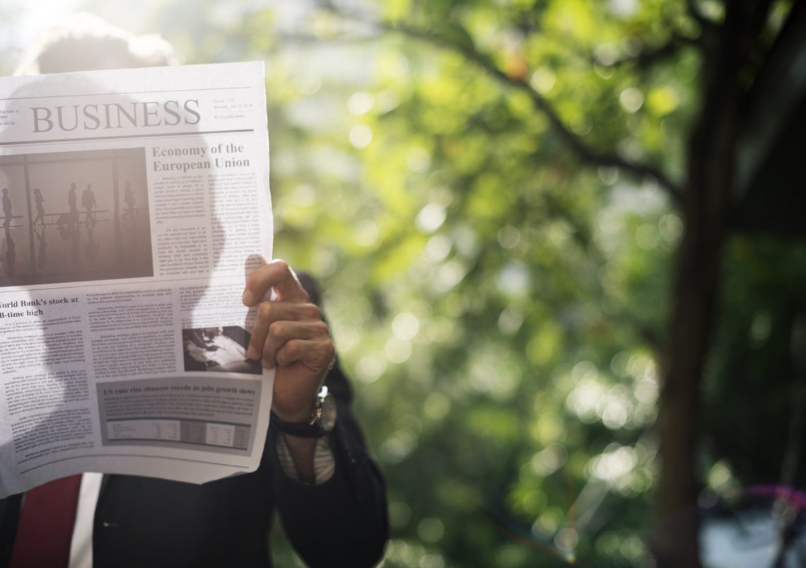 Man reading business newspaper