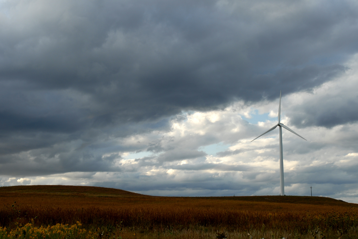 A wind turbine on lonely moor under unsettled skies