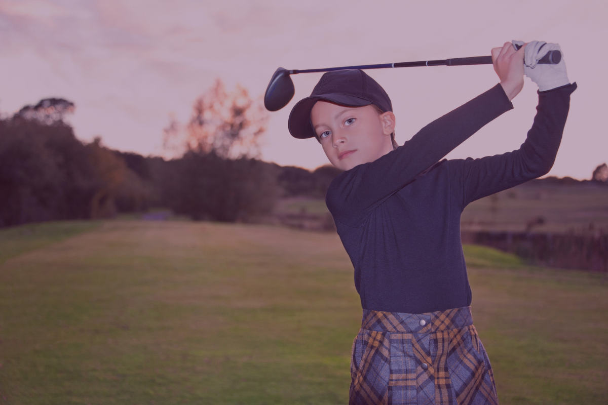young girl at the end of a golf swing