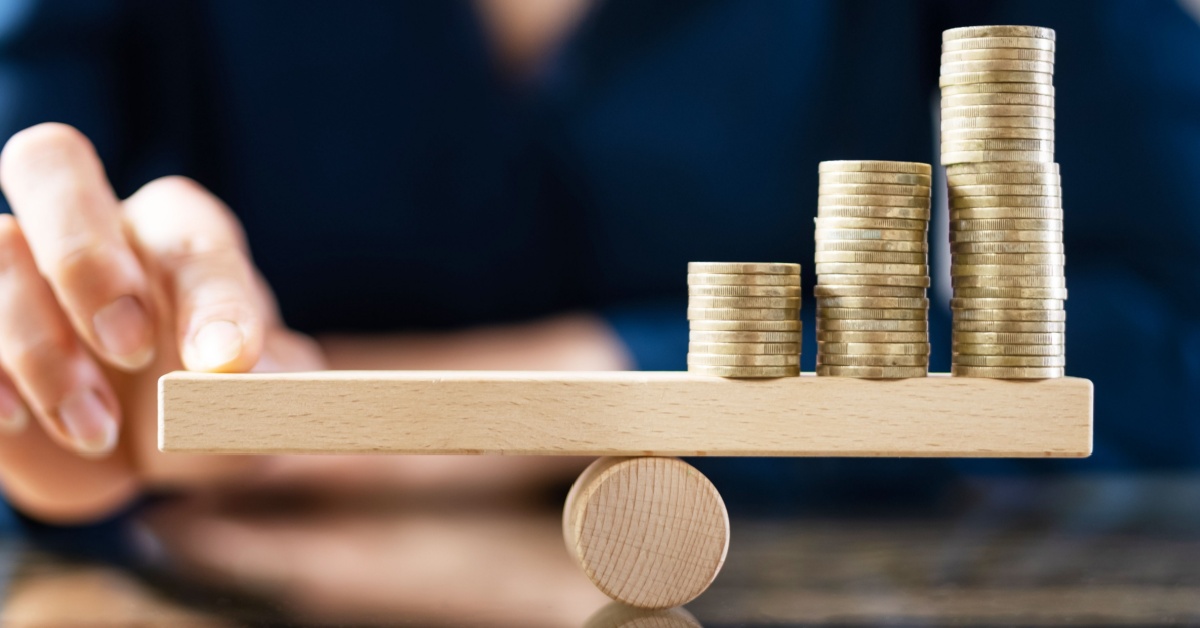 Stacks of coins balancing on a beam.