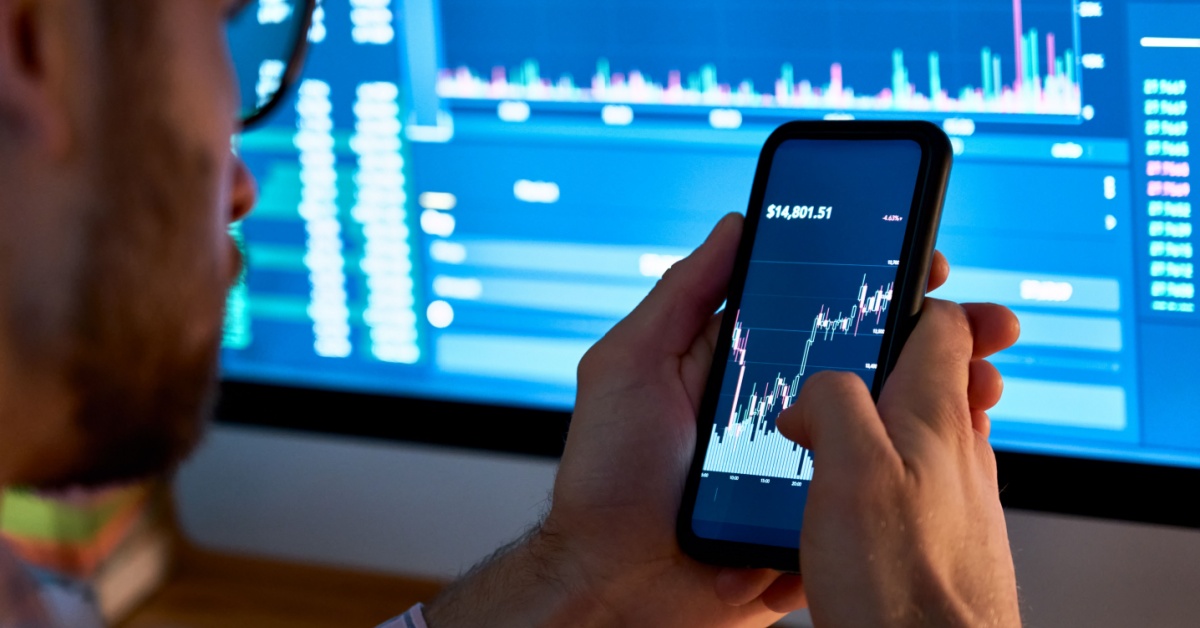 An investor looking at an index on his phone.