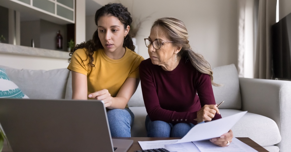A woman and her daughter going through documents together.